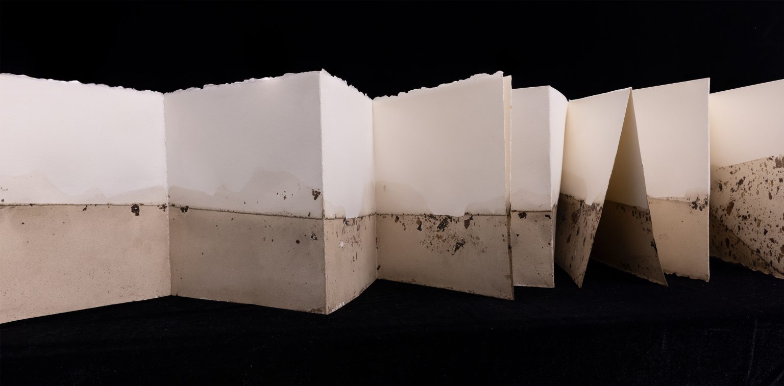 folded book with brown stains on a black background