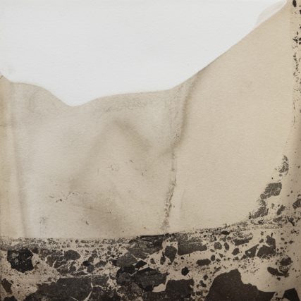 detail of a stained piece of watercolour paper with watery brown patches and strange chunks of darker brown material